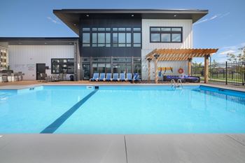 A large swimming pool in front of a modern building.